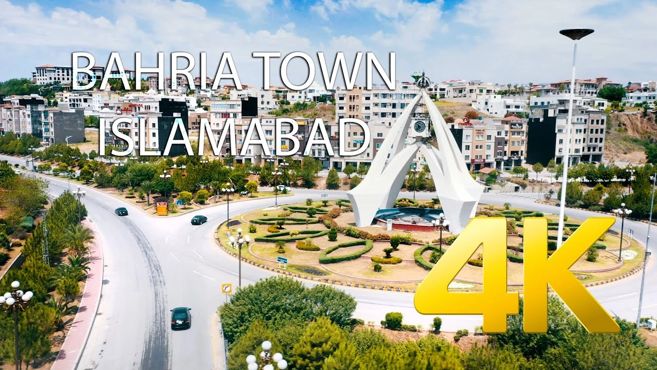 Aerial view of Bahria Town Islamabad featuring the iconic monument, landscaped roundabout, and surrounding residential buildings in 2026.